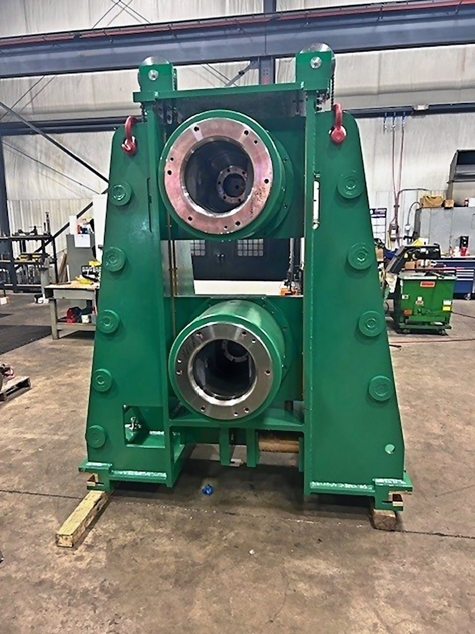 Green stand housing two large machined bearing housings, set on timbers