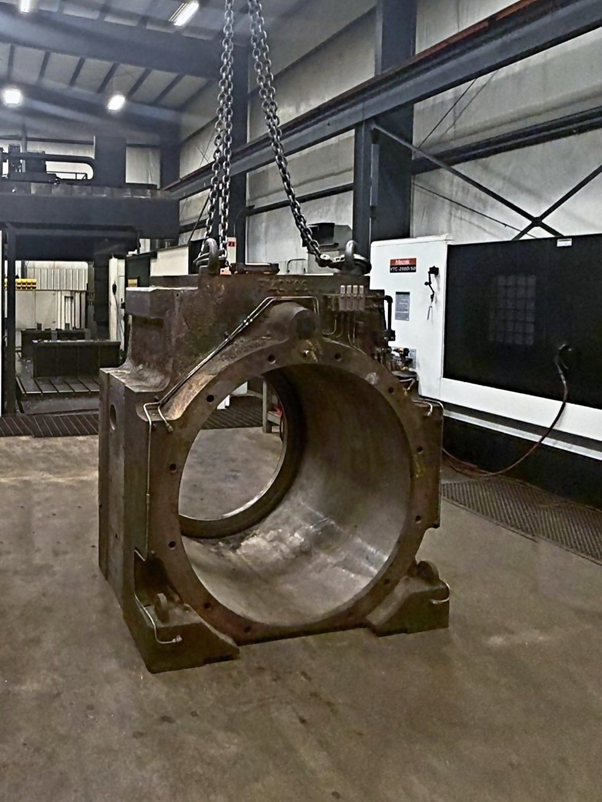 Worn chock with hydraulic lines hanging from the overhead crane