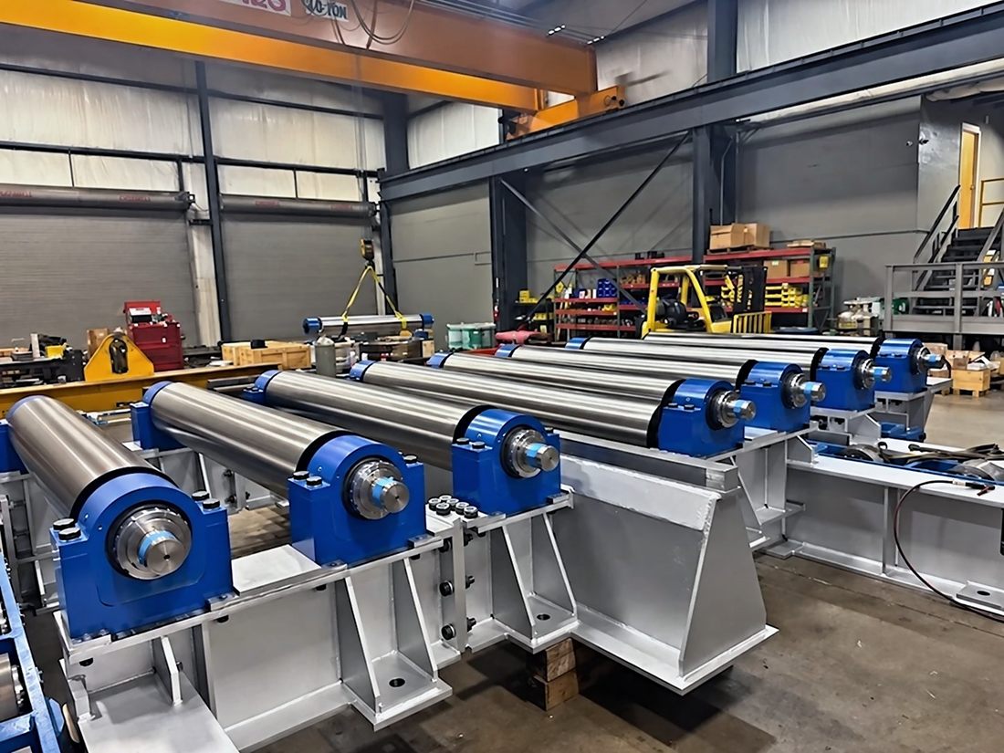 Roller table: polished rolls in blue bearing housings on new silver frames
